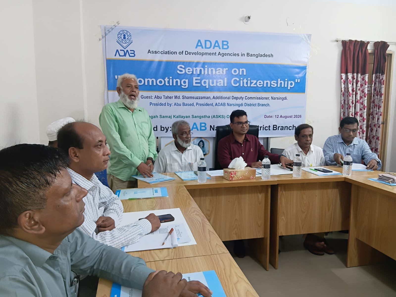 Attendee in the foreground at an ADAB seminar on promoting equal citizenship